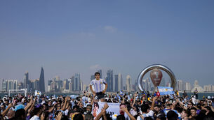 <p>BRINGING THE COLOUR: Argentina's soccer fans gather holding a life-size cutout figure of late soccer star Diego Maradona on the eve of the World Cup group C soccer match between Argentina and Saudi Arabia, in Doha. Pic: AP Photo/Jorge Saenz</p>