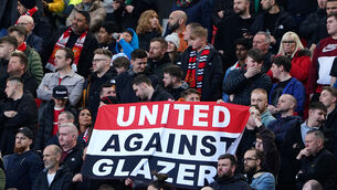 <p>END OF AN ERA: Manchester United fans in the stands hold up a banner reading "United Against Glazer",</p>