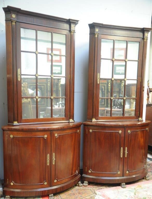 A pair of Regency mirror-door bow-fronted cabinets at Marshs.