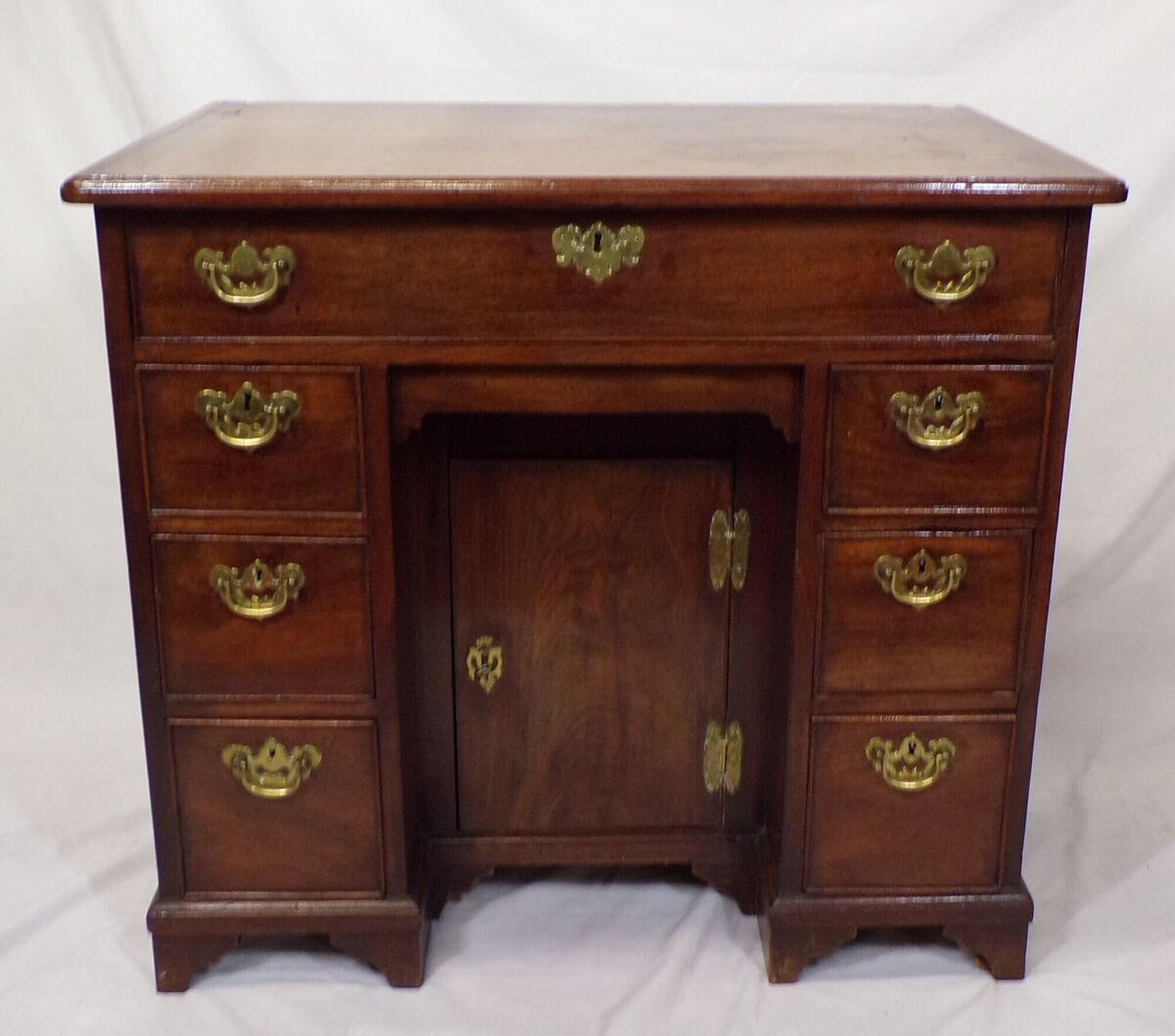 A George II kneehole desk at Woodwards.