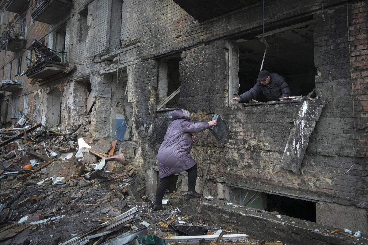 People gather their belongings from a damaged house after Russian shelling in the town of Vyshgorod outside the capital Kiev, Ukraine, on Thursday. Picture: AP Photo/Efrem Lukatsky People gather their belongings from a damaged house after Russian shelling in the town of Vyshgorod outside the capital Kiev, Ukraine, on Thursday. Picture: AP Photo/Efrem Lukatsky