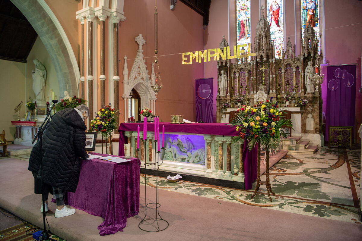  Angela O'Keeffe, a colleague of Vicky Phelan's in WIT,  signing a book of condolence in front of the alter at the Church of the Assumption in Mooncoin. Picture: Dan Linehan