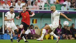 <p>Morocco's Noussair Mazraoui, left, and Sofyan Amrabat, right, defend against Belgium's Kevin De Bruyne during the World Cup group F soccer match between Belgium and Morocco, at the Al Thumama Stadium in Doha, Qatar, Sunday, Nov. 27, 2022. (AP Photo/Frank Augstein)</p>