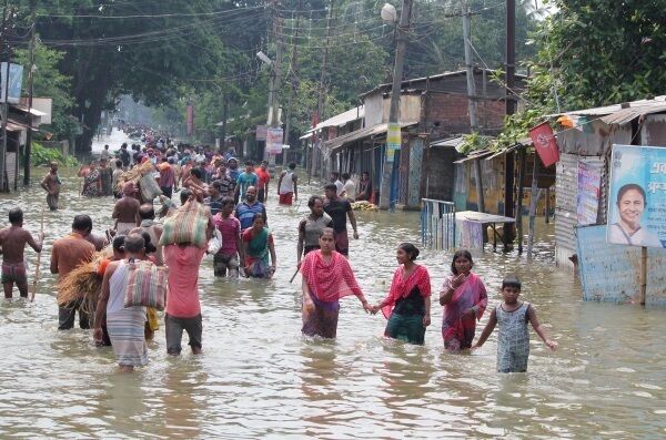 AUGUST: Indian residents wade through flood waters inWest Bengal on August 17. At least 221 people died and more than 1.5m weredisplaced by monsoon flooding across India, Nepal and Bangladesh. Picture: STR/AFP/Getty Images