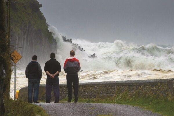 OCTOBER: Fishermen look out from the Glen Pier, Ballinskelligs, Co Kerry, at the Atlantic during the record-breaking ex-hurricane Storm Ophelia. Three lives were lost and the nationwide shutdown is thought to have saved many more. Picture: Stephen Kelleghan