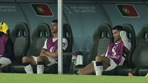 <p>BENCHED: Portugal’s Cristiano Ronaldo, right, sits on the bench. Pic: Hassan Ammar/AP</p>