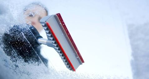iStock-187918844.jpg Person scraping ice from a windshield