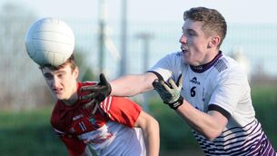 <p>LAY-OFF: Skibbereen Community School's Shane Carey hand-passing the ball clear of Pobalscoil Chorca Dhuibhne's Cian Ó Cinnéide in the Corn Uí Mhuirí at Banteer. Pic: Denis Minihane.</p>