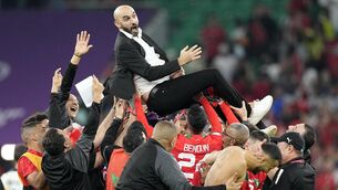 <p>HISTORY MAKERS: Morocco boss Walid Regragui is held aloft by his players. Pics: Martin Meissner/AP</p>