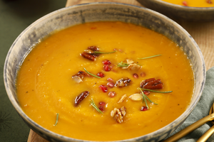 Spicy sweet potato soup with maple almonds and pecans