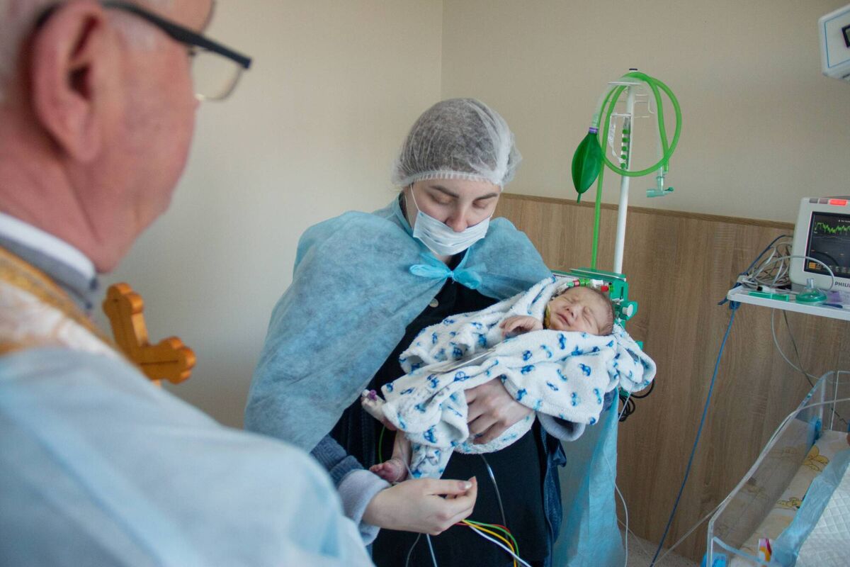 A baby receives assistance from a CCI surgeon A baby receives assistance from a CCI surgeon