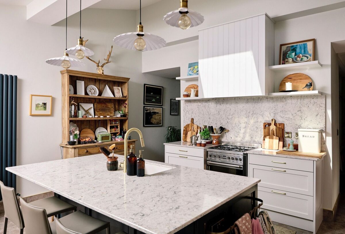 Sharon Holland's kitchen features smart storage in a broken-plan layout that semi separates her dining room from the kitchen. Sharon Holland's kitchen features smart storage in a broken-plan layout that semi separates her dining room from the kitchen.