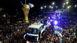 <p>OVERDUE BUS: Argentina's players celebrating on board a bus with supporters. Picture: TOMAS CUESTA/AFP via Getty Images)</p>