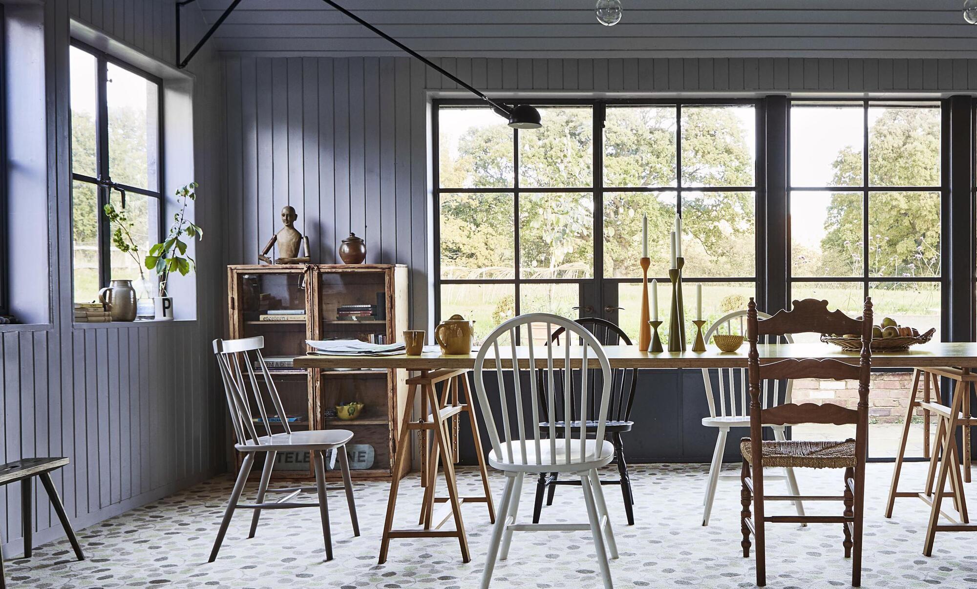 A harlequin set of chairs ranging over a century are given new life in a simple Shaker-inclined kitchen. Similar large rug, Morris & Co, Boughs, €923, rugs.ie. Picture: Carpetright