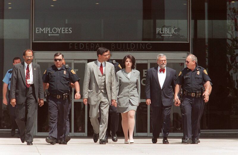 Former White House intern Monica Lewinsky is escorted by police officers, federal Investigators and her attorney William Ginsburg as she leaves the Federal Building on 28 May 1998 in Westwood, California. Picture: Vince Bucci/AFP via Getty Images