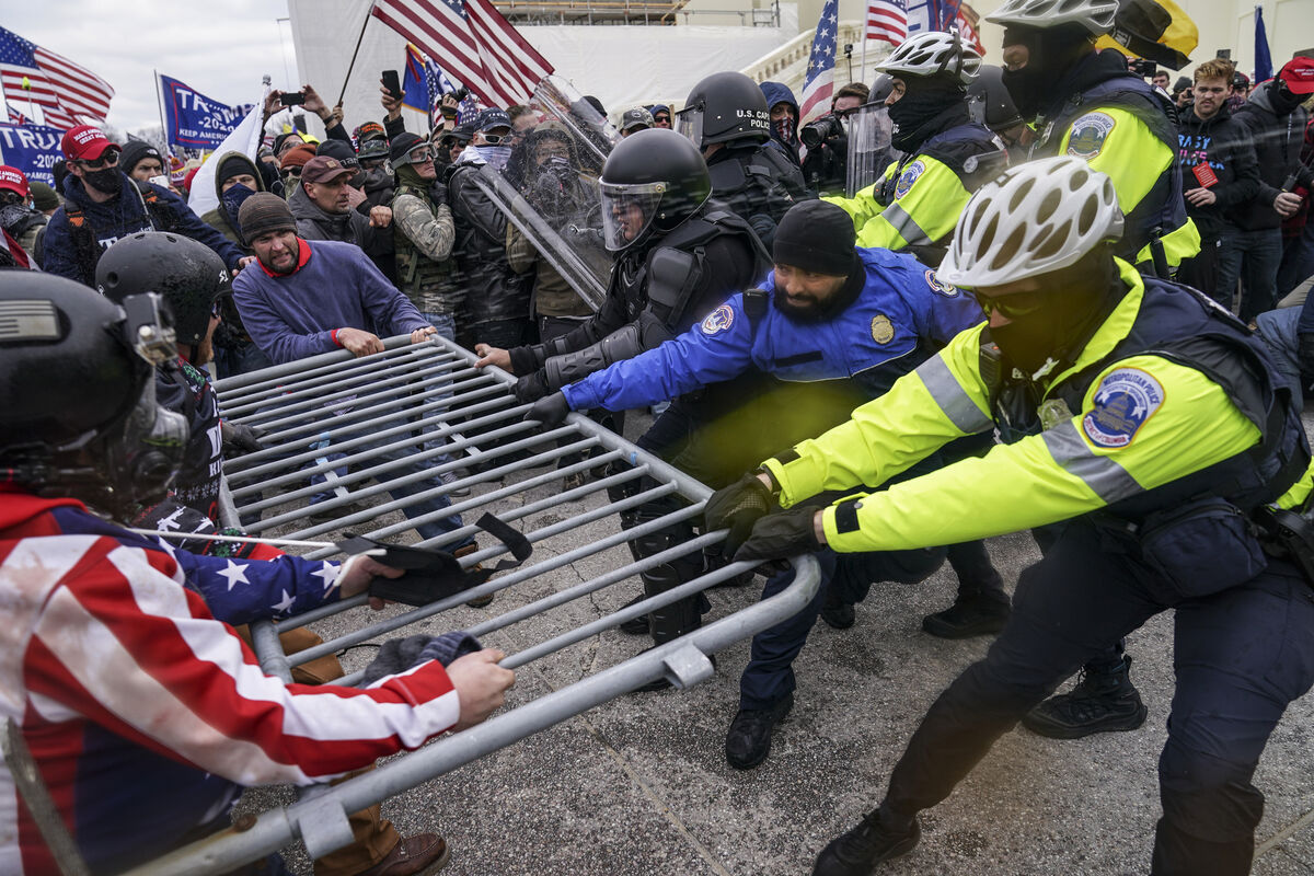 Trump supporters try to break through a police barrier during the insurrection. Picture: AP Photo/John Minchillo