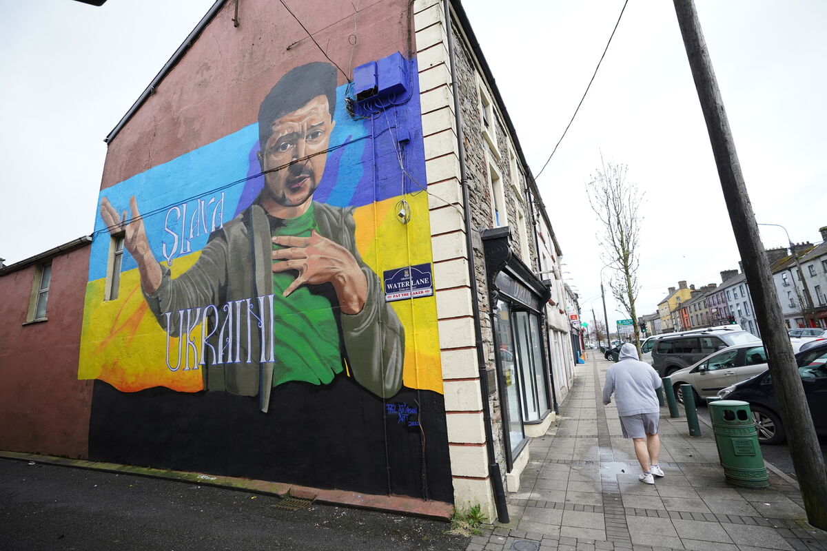 People pass a mural of President of Ukraine Volodymyr Zelenskyy, by the artist Phil Atkinson in Granard, County Longford, Ireland. Picture date: Tuesday April 5, 2022.