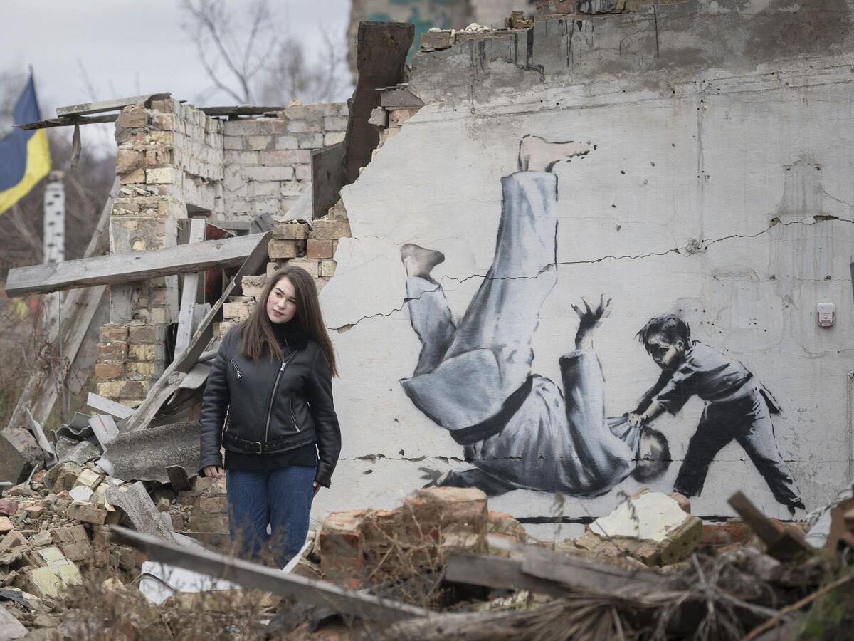 One of the murals in Borodianka, Ukraine, by the artist Banksy. It depicts judo expert Vladimir Putin being floored by a Ukrainian girl. The British artist also sold off 50 limited edition prints at £5,000 each to raise money for victims of the war.(AP Photo/Andrew Kravchenko)