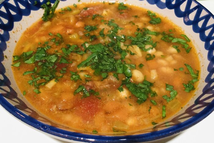 Winter vegetable and bean soup with spicy sausage