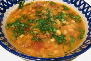 Winter vegetable and bean soup with spicy sausage