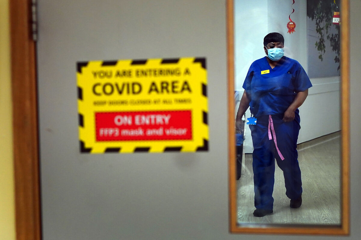 A nurse walks through a covid ward at King's College Hospital, in south east London. Picture date: Tuesday December 21, 2021.