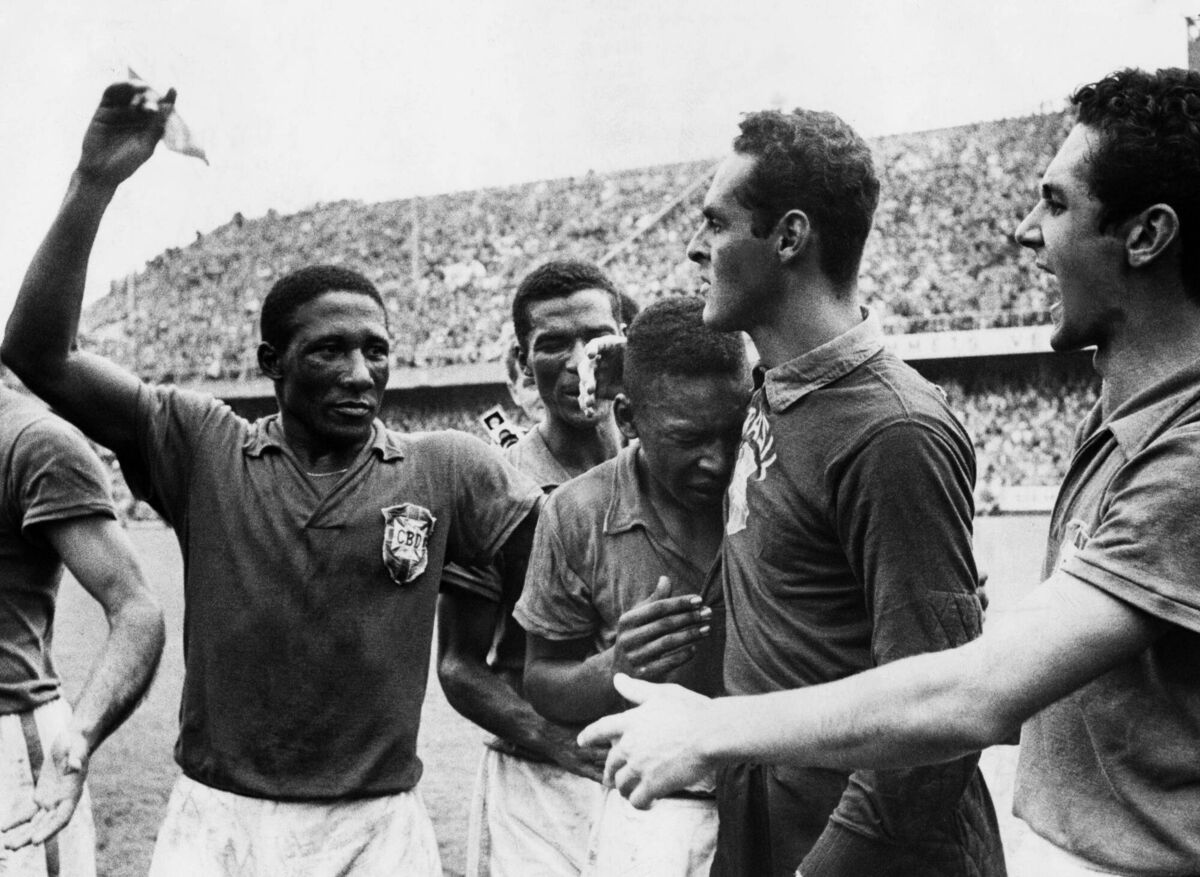 WEEPING: An emotional Pele cries on his teammate's shoulder in 1958. (Picture: Keystone-France\Gamma-Rapho via Getty I mages) 