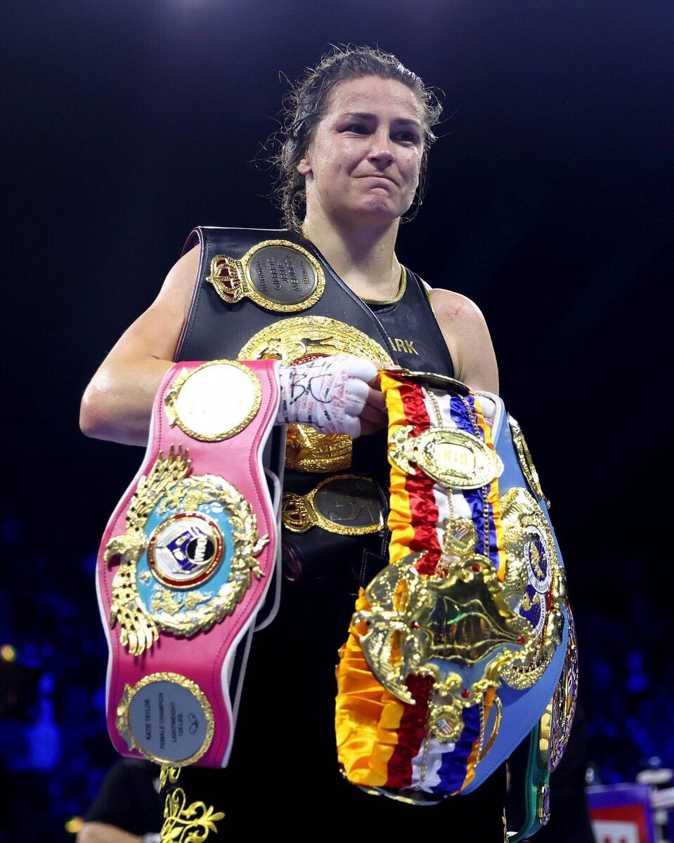 PHENOMENAL: Katie Taylor poses for a photograph with her title belts after defeating Karen Elizabeth Carabajal during the IBF, WBA, WBC and WBO Undisputed Lightweight World Title fight. Pic: James Chance/Getty Images