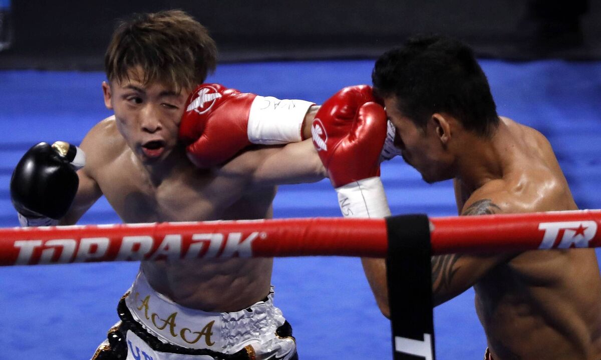 THE MONSTER: WBA/IBF bantamweight champion Naoya Inoue (L) of Japan trades punches with Michael Dasmarinas of the Philippines.