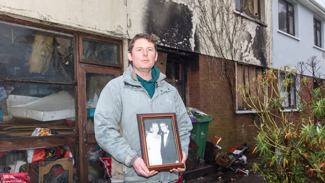 <p>David Lynch with a photo of his parents Noirín, who predeceased her husband in 2016, and John. It is one of the few items David has salvaged from their home in Waterpark, Carrigaline, Cork, after the fire which claimed Sean's life just before Christmas. Picture: David Creedon</p>