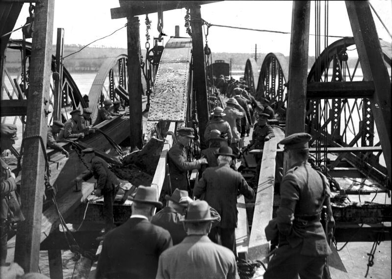 Civilians are led across the railway bridge at Rochestown, Cork in early 1923. It had been blown up by anti-Treaty forces some months previously. Irish Examiner Archive