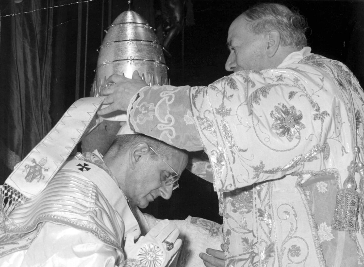 In this file photo taken on June 30, 1963, Alfredo Cardinal Ottaviani, Italian member of the Vatican Curia, places the Tiara Crown on the head of Pope Paul VI during the coronation ceremony outdoor, in front of St. Peter's. His papacy is  remembered by his decision to ban contraception for Catholics in a 1968 encyclical.