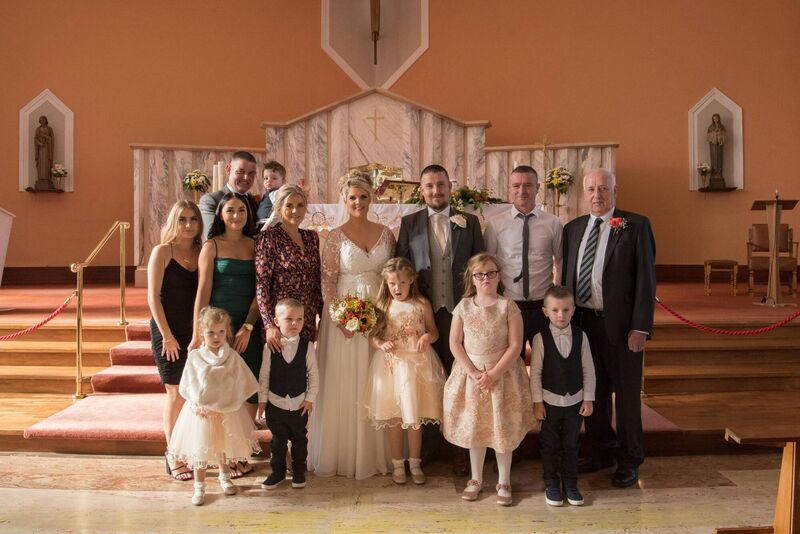 Rachel and Trevor and their daughters Emily-Belle and Katie-Rose with the bride's family