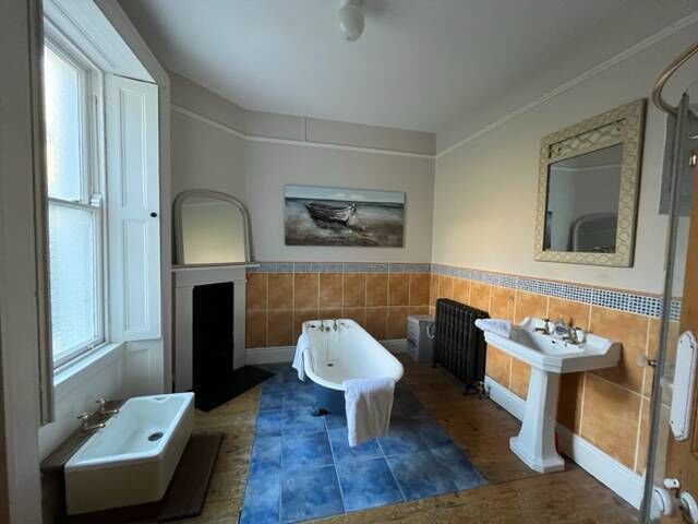Main bedroom with quirky foot bath and antique Victorian rad Main bedroom with quirky foot bath and antique Victorian rad