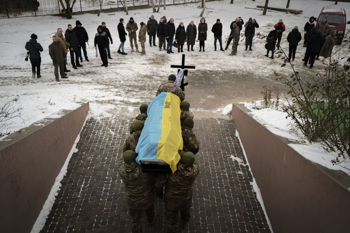 Ukrainian soldiers carrying the coffin of their fallen comrade in Bucha, Ukraine, Thursday, Jan. 12, 2023. Picture: AP Photo/Bela Szandelszky