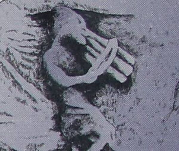 Detail of musician carved on church.