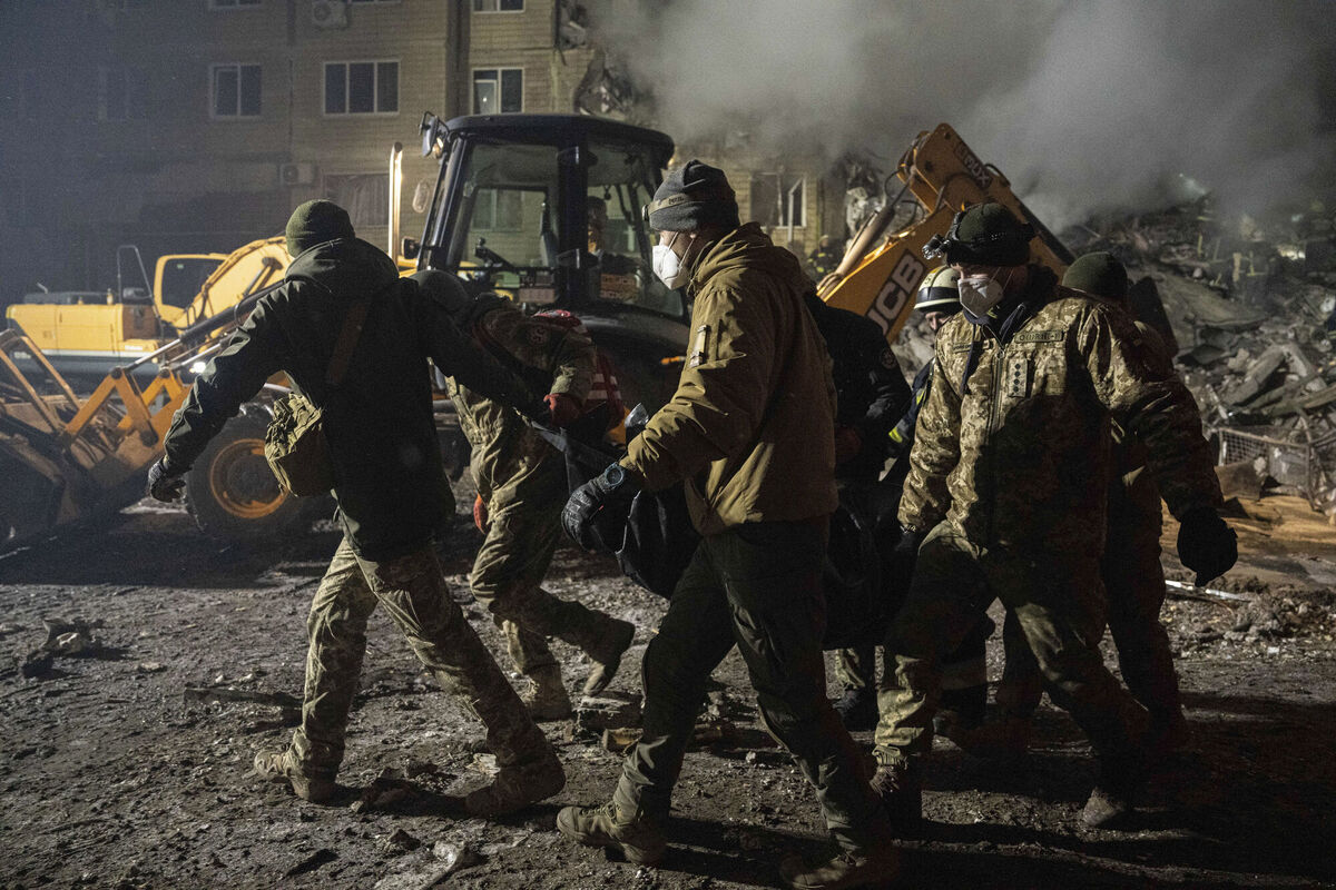 Ukrainian servicemen carry a body of a man who was killed by a Russian rocket attack at residential neighborhood in the southeastern city of Dnipro. Picture: AP Photo/Evgeniy Maloletka