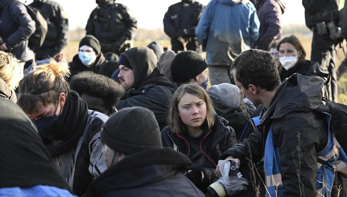 Police officers have encircled a group of activists and coal opponents with climate activist Greta Thunberg, center, on the edge of the Garzweiler II opencast lignite mine during a protest action by climate activists after the clearance of Luetzerath, Germany, Tuesday, Jan. 17, 2023. After the eviction of Luetzerath ended on Sunday, coal opponents continued their protests on Tuesday at several locations in North Rhine-Westphalia. (Federico Gambarini/dpa via AP)