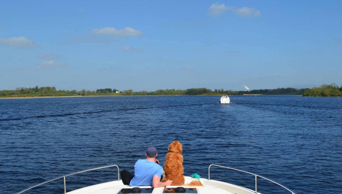 Tom Breathnach, Irish Examiner travel editor, cruising along the River Shannon with his dog.