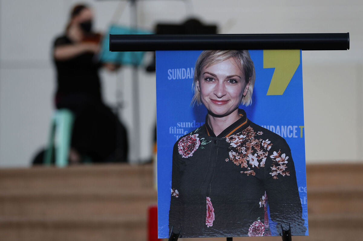A musician plays a violin behind a photograph of cinematographer Halyna Hutchins during a vigil in her honor in Albuquerque in October 2021. Picture: AP Photo/Andres Leighton, File