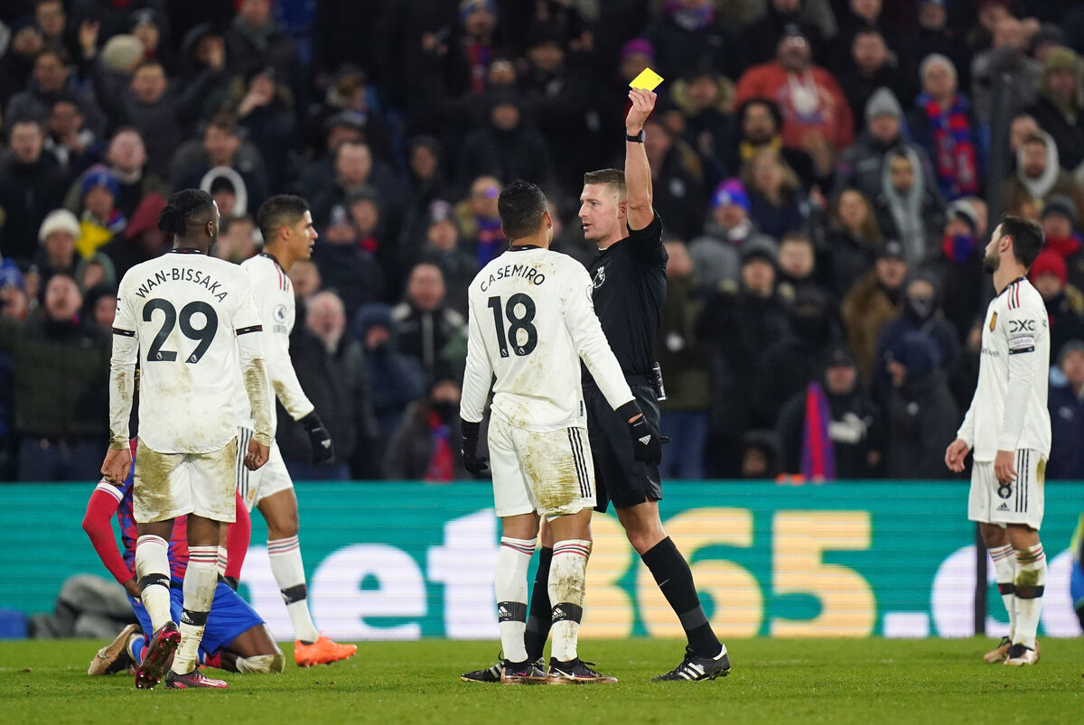 YELLOW PERIL: Manchester United's Casemiro is shown a yellow card by referee John Brooks, resulting in a suspension which will rule him out of his side's next match against Arsenal.