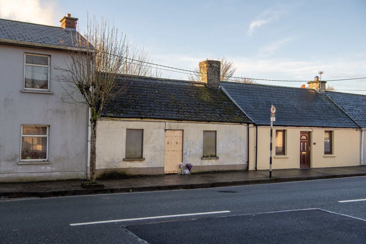  Flowers left outside the boarded-up vacant house on Beecher Street, Mallow, where the body of Tim O'Sullivan was discovered. Picture: Dan Linehan