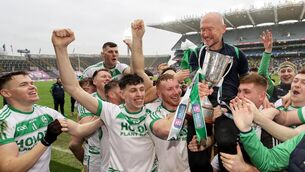 <p>CHAMPIONS AGAIN: Ballyhale Shamrocks trainer Niall Lacey celebrates after the game with the trophy. Pic: INPHO/Laszlo Geczo</p>