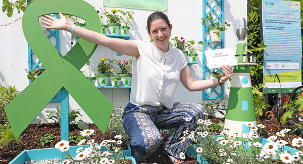 Trisha McKeever, Shine, celebrates its Green Ribbon Garden being recognised at the Postcard Garden series. Picture: Julien Behal.
