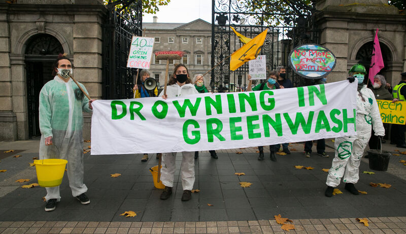 Extinction Rebellion activists poured buckets of green sludge (water-soluble food dye) at Leinster House in November 2021. The symbolic gesture represented greenwashing â the various PR techniques that "camouflage the damage and destruction" to the environment present in many industrial activities. Picture: Gareth Chaney/Collins Extinction Rebellion activists poured buckets of green sludge (water-soluble food dye) at Leinster House in November 2021. The symbolic gesture represented greenwashing â the various PR techniques that "camouflage the damage and destruction" to the environment present in many industrial activities. Picture: Gareth Chaney/Collins
