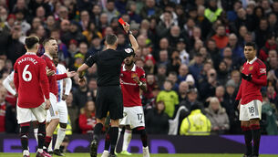 <p>Referee Andre Marriner shows a red card to Manchester United's Casemiro, right, during the English Premier League soccer match between Manchester United and Crystal Palace, at the Old Trafford stadium in Manchester, England, Saturday, Feb. 4, 2023. (AP Photo/Dave Thompson)</p>