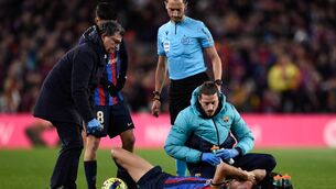 <p>Barcelona midfielder Sergio Busquets is injured during the match with Sevilla at the Camp Nou on Sunday. Picture: Adria Puig/Anadolu Agency via Getty Images</p>