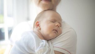 Unrecognizable mom with a newborn boy.
