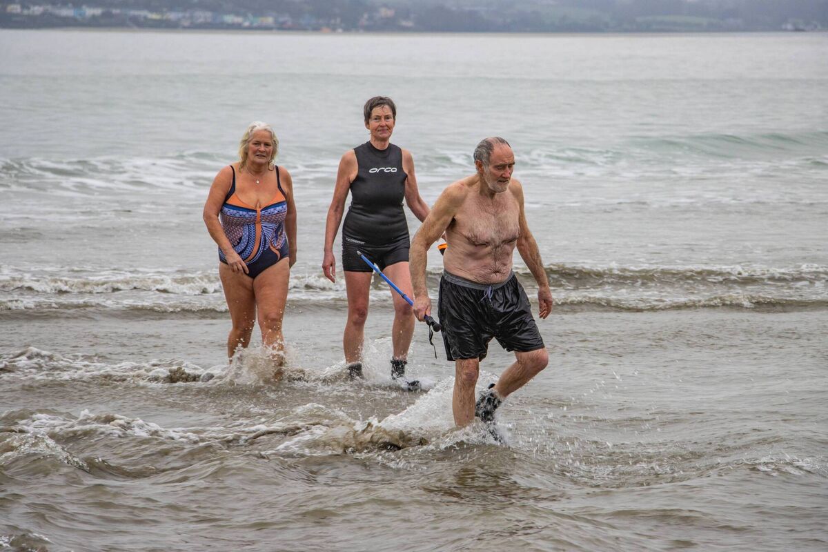 Emerging from the cold water at Coolmain Beach in Kilbrittain are (left to right) Susan Nicholson, Bernadette Gallagher and Paddy Conoghan. Photo: Gearóid Holland