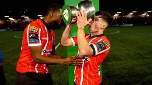 <p>DRINK IT IN: Derry’s Sadou Diallo and Adam O’Reilly with The President's Cup. Pic: INPHO/Ryan Byrne</p>