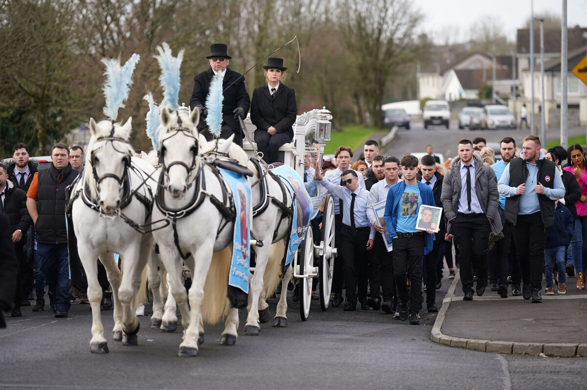 The horse-drawn carriage carrying the coffin of John Keenan arrives for his funeral. Picture: Niall Carson/PA Wire